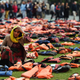 Rahela Sidiqi, of Women for Refugee Women sits amongst life jackets.